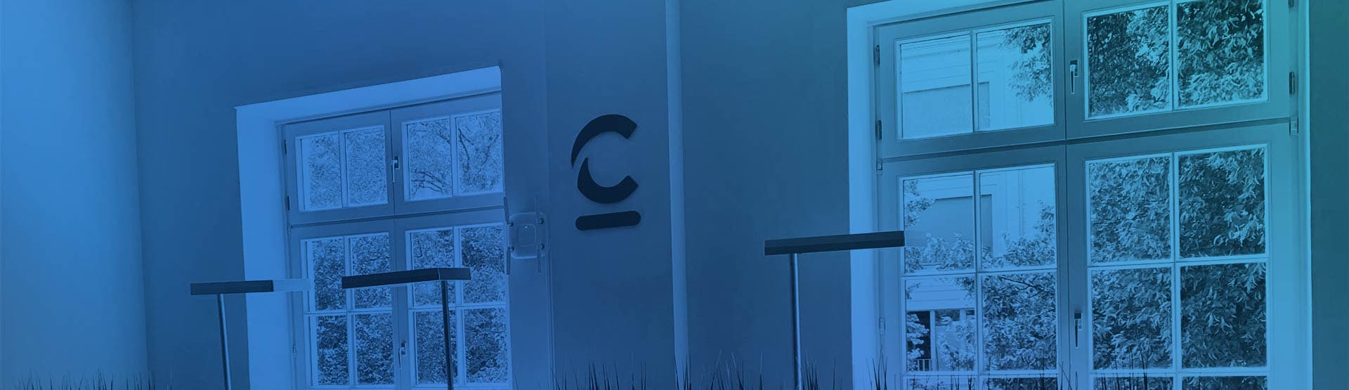 office wall with a c on it, windows and desk lights