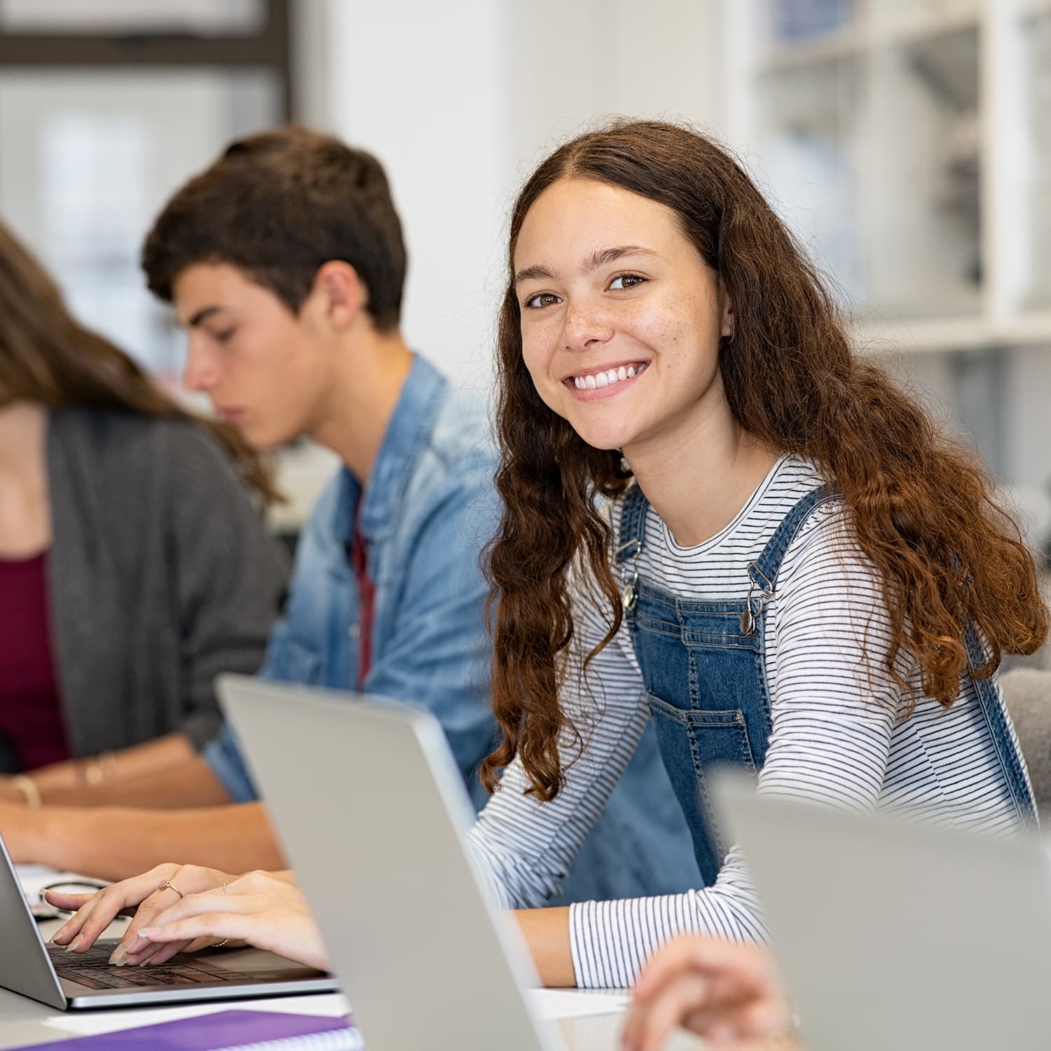 confident girl at at notebook in a classroom